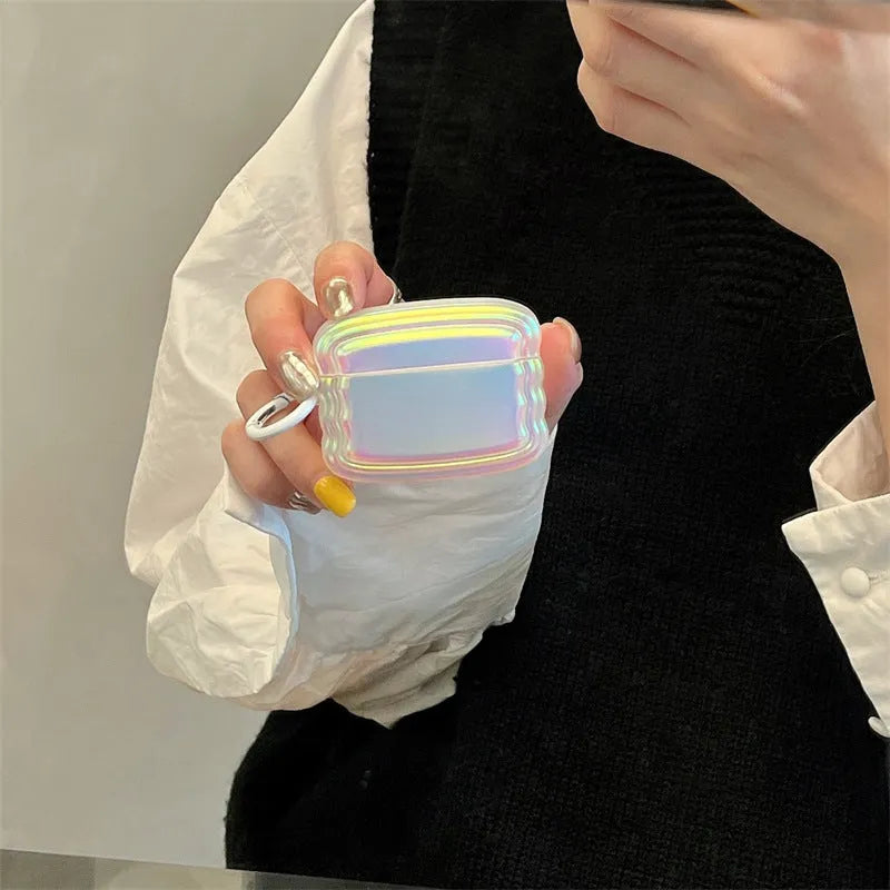 Silicone AirPods case with holographic laser ring design on a white charging case.