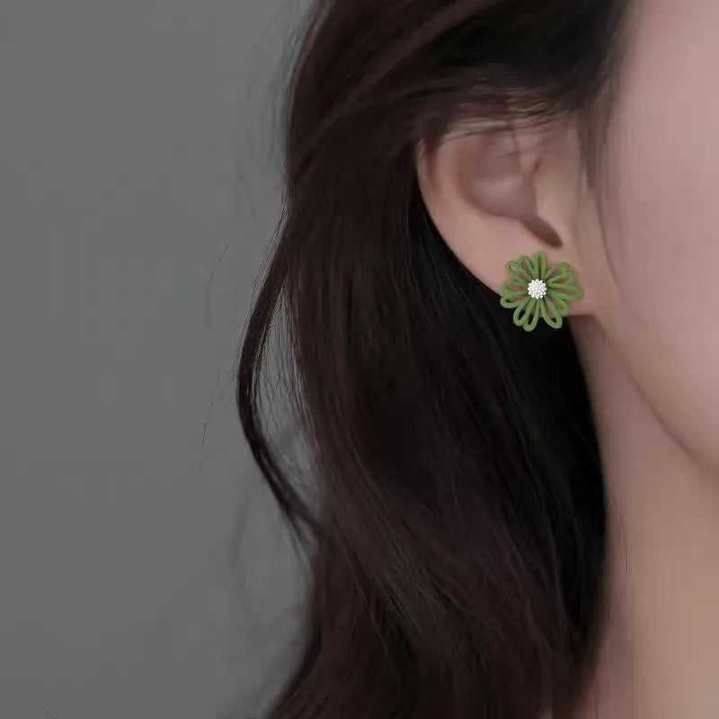 Alloy flower stud earrings in three two-tone colour combinations: white and green, yellow and white, blue and orange