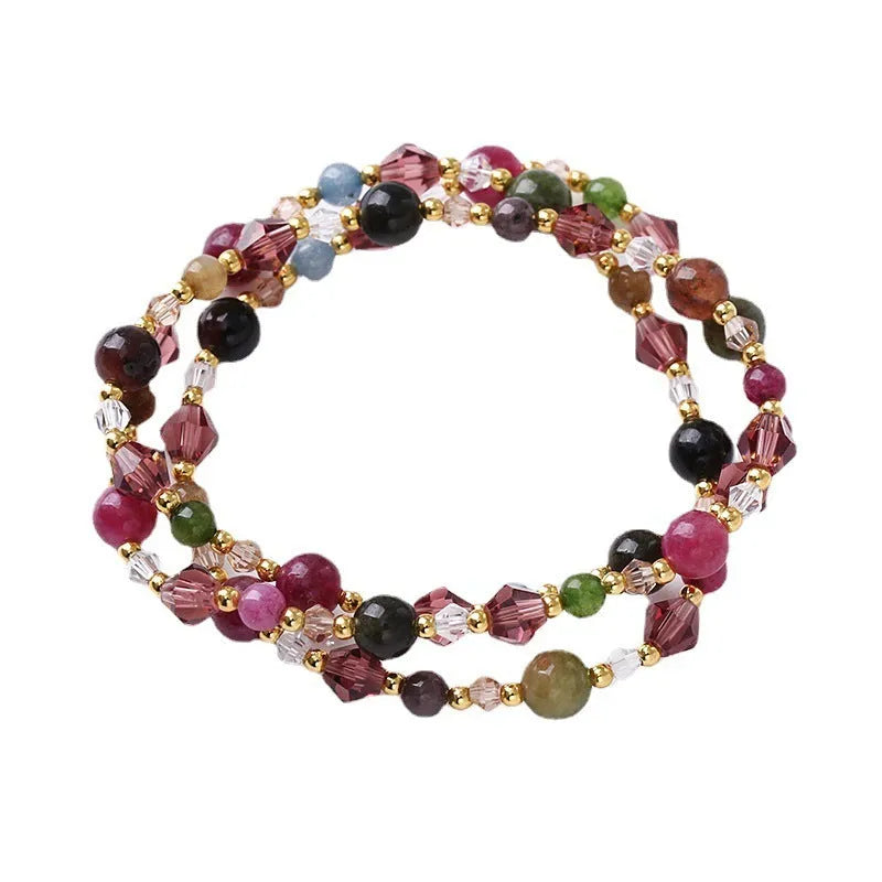 Handcrafted three-ring crystal bracelet with tourmaline, strawberry quartz and amethyst beads on adjustable cord