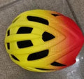 Orange road bike mountain riding helmet with 16 vents and in-mold PC EPS shell on white background