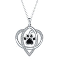 Close-up of electroplated copper paw print necklace pendant on adjustable cross chain