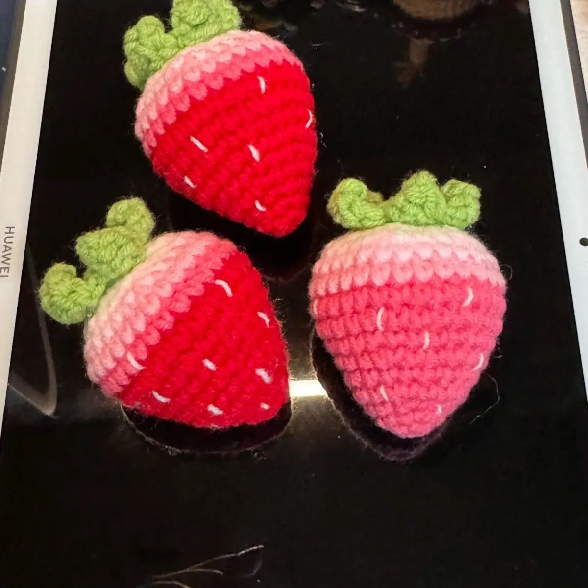 Plush strawberry pendant keychain in pink with metal ring on a white background