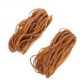 Circular natural rubber rings in natural colour on a surface in a 500g bulk bag