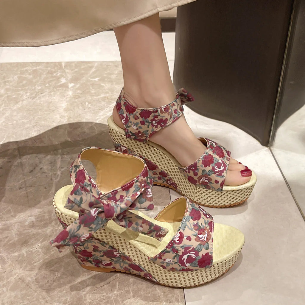 Women's peep toe sandals with cloth upper, ankle-strap buckle, and rubber sole in pink floral colour