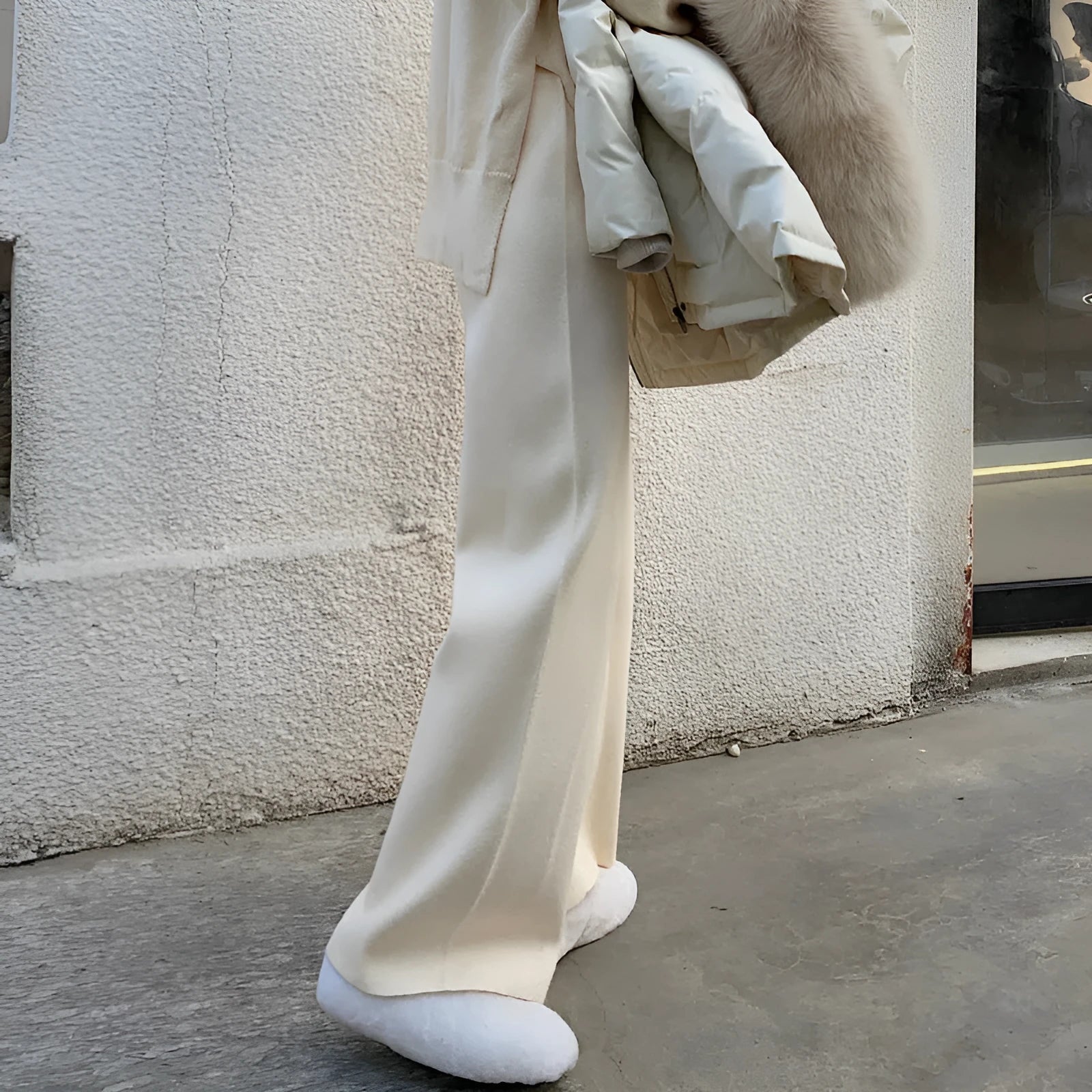 Women's high waist knitted wide-leg trousers in cream white colour with elastic waistband