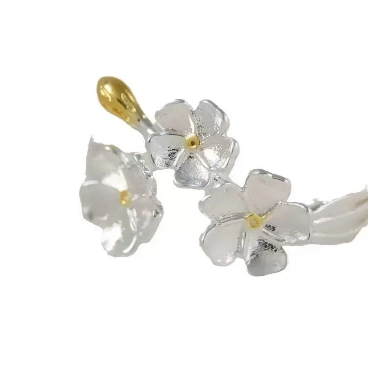 Three-dimensional jasmine and camellia flower ring with open-mouth design on zinc alloy.