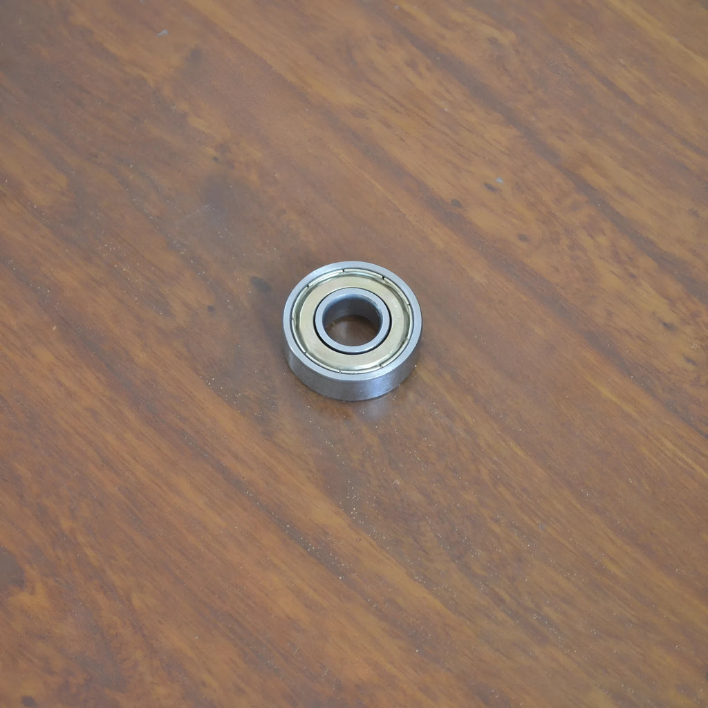Carbon steel bearing 6000zz 10x26x8mm with iron retainer on white background