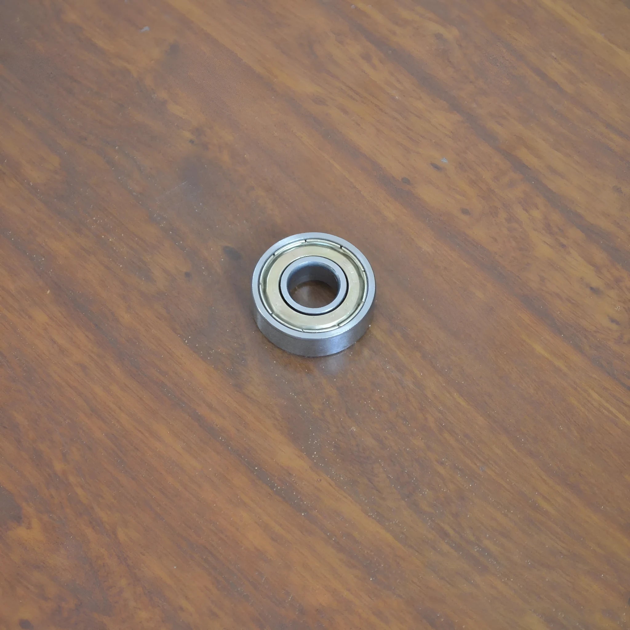 Carbon steel bearing 6000zz 10x26x8mm with iron retainer on white background