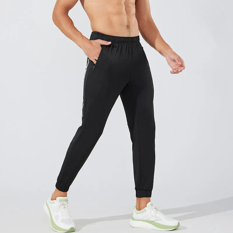 Man wearing black full-length polyester running trousers with a mid waist.
