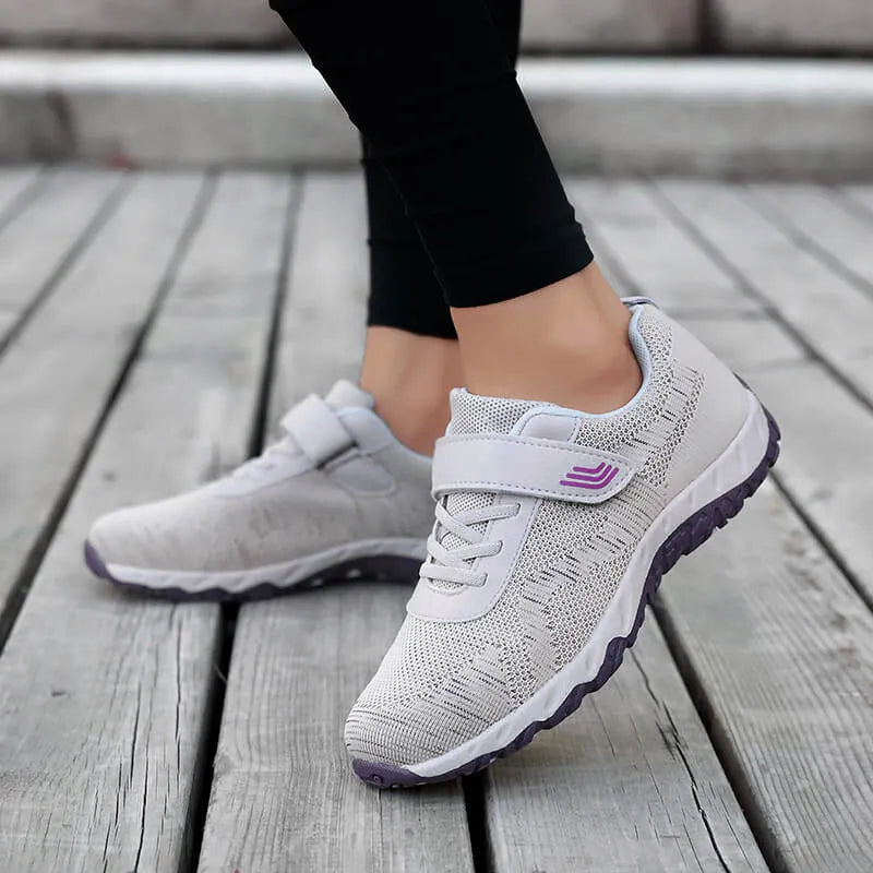 Women's grey purple low top wedge heel shoes with velcro strap and mesh upper.
