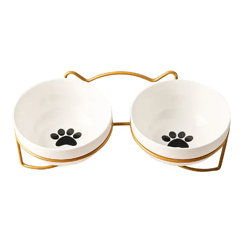 White ceramic cat bowl with cat footprint design in a black iron frame with cat ears.