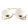 White ceramic cat bowl with cat footprint design in a black iron frame with cat ears.