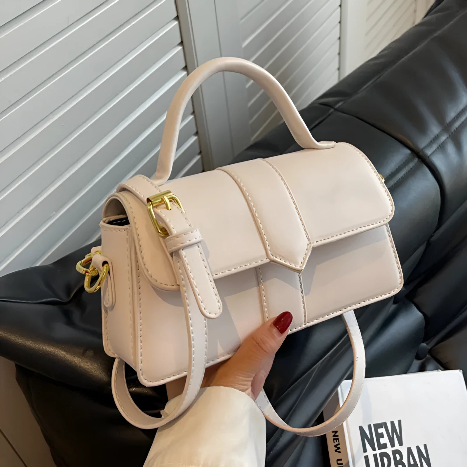 Women's beige PU messenger bag showing internal file organisation and sandwich pocket exterior