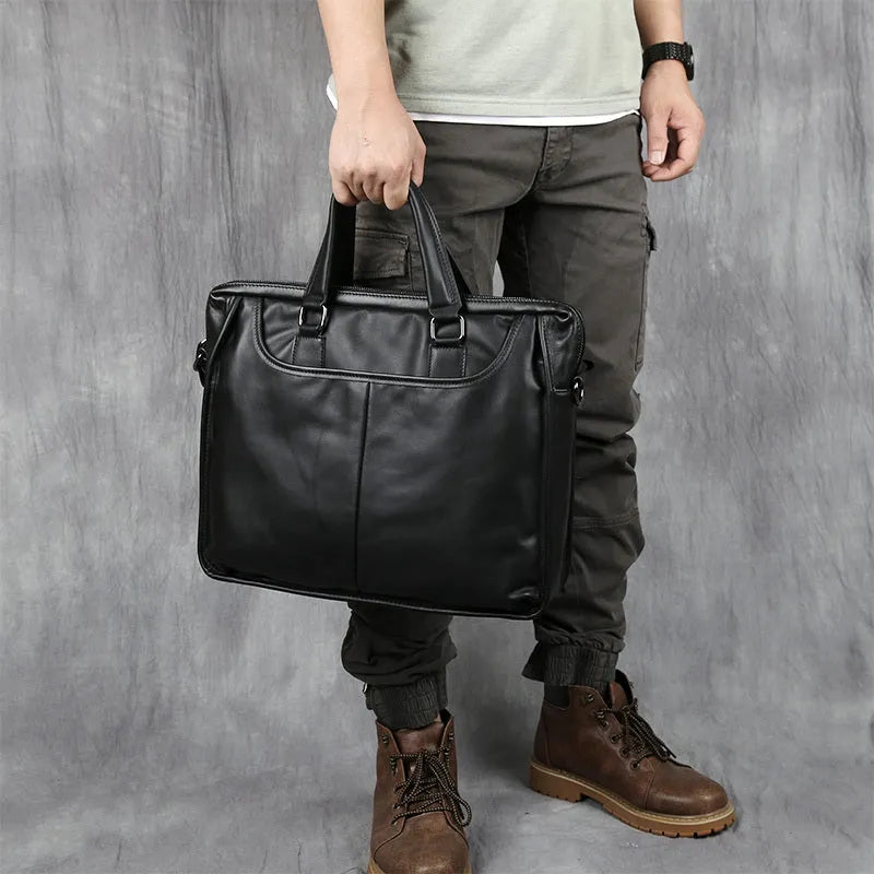 Black men's leather leisure briefcase with top layer cow hide, zipper closure, and shoulder strap