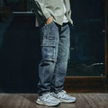 Man wearing blue loose straight-leg denim jeans with a zip fly, casual style.