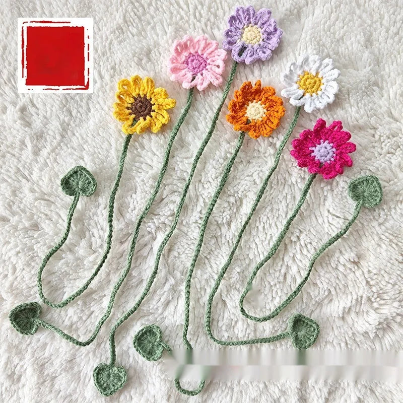 Hand-crocheted daisy wool bookmark with flexible wire on open book