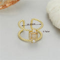 Gold-plated copper open ring with U-shaped asymmetric design and adjustable opening.