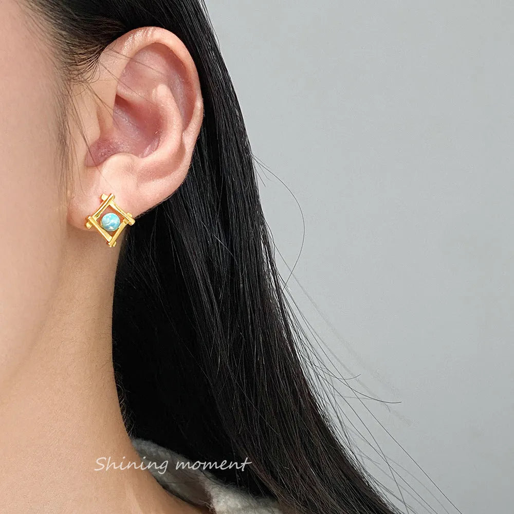 Geometric cross stud earrings in sterling silver with quadrangle shape and butterfly fastenings