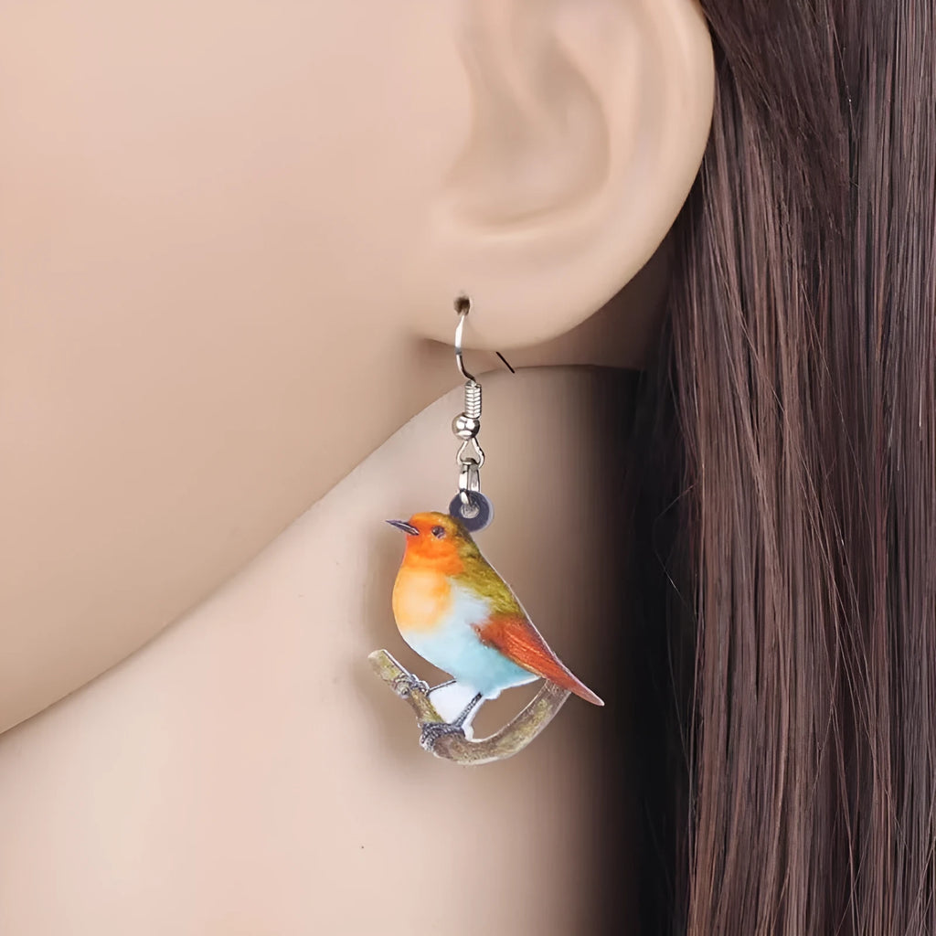Acrylic blue titmouse pendant earrings with geometric animal zodiac designs and snake pattern details
