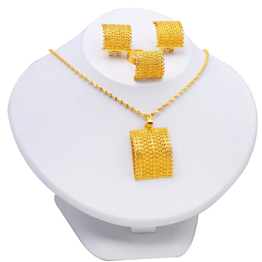 Gold colour copper bridal jewellery set with necklace, earrings, and ring on display
