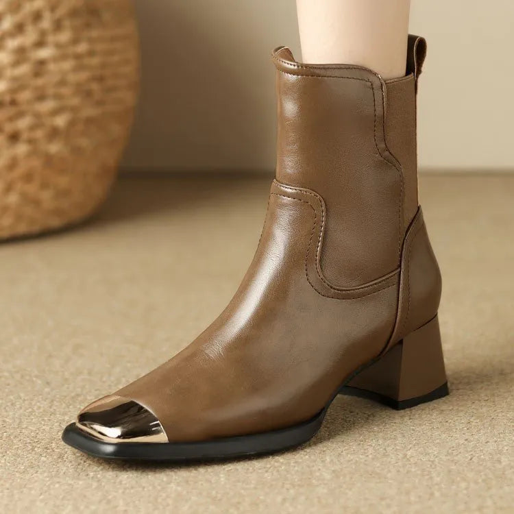 Brown women's Martin boots with high heel and side zip on a white background.