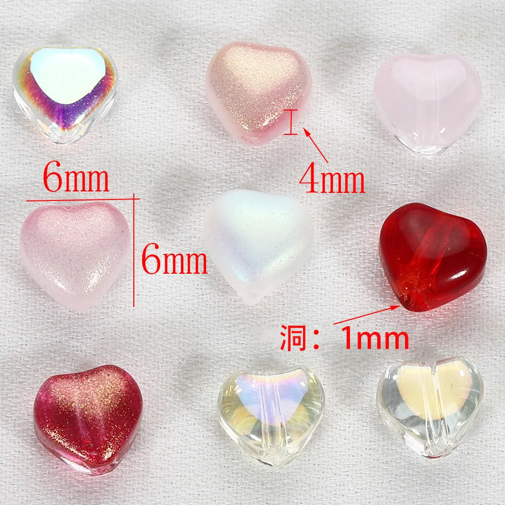 20 transparent acrylic love heart beads in assorted colours on white background