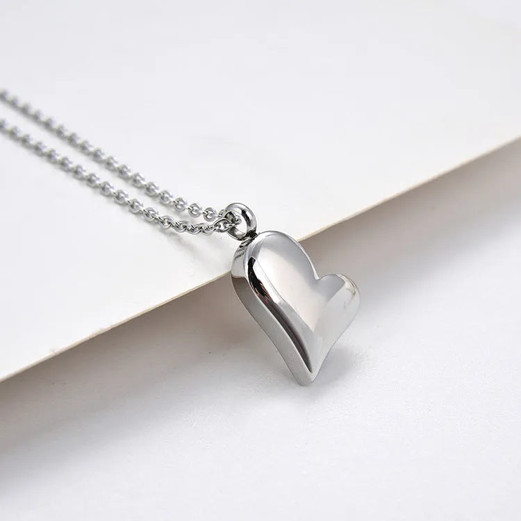 Silver curved peach heart stainless steel pendant necklace on adjustable chain