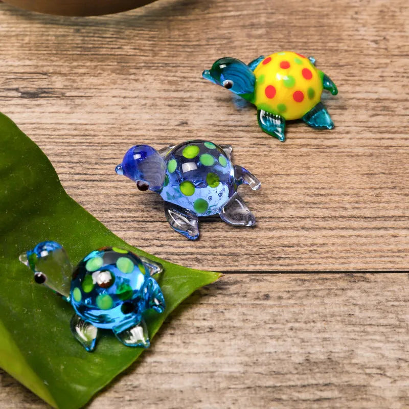 Geometric glass turtle ornament in a modern style displayed on a wooden surface.