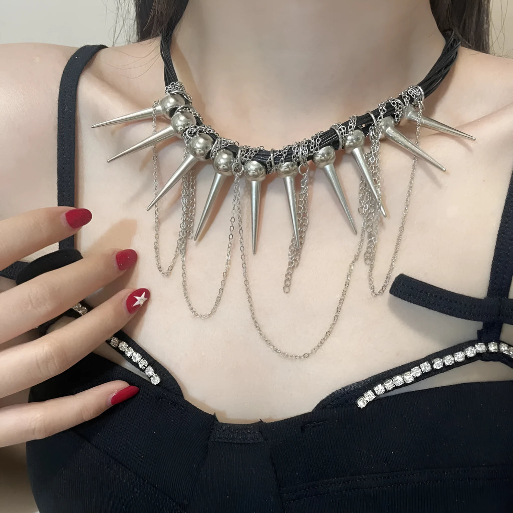 Leather necklace with winding tassel, round beads, and silver point rivet details.