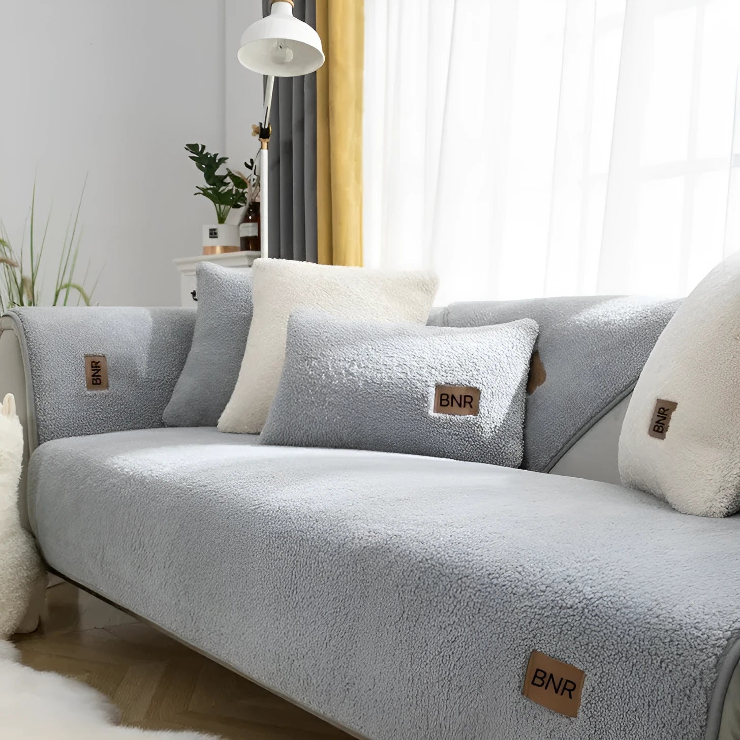 Lambswool solid colour sofa cover in blue on a sofa, showing simple slipcover style.