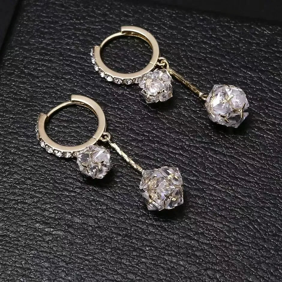 Silver drop earrings with a tassel and rhinestone ball pendant on copper findings.