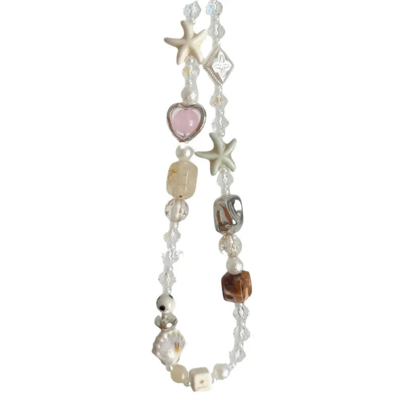 Bohemian beaded mobile phone charm in Island Sweetheart colour with alloy chain and decorative beads on a plain background