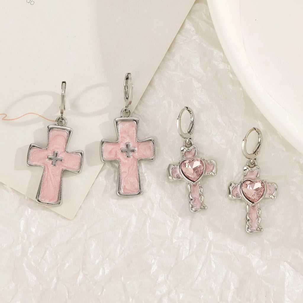 Women's alloy earrings with cross and character designs in five colour options including white cross and antique silver