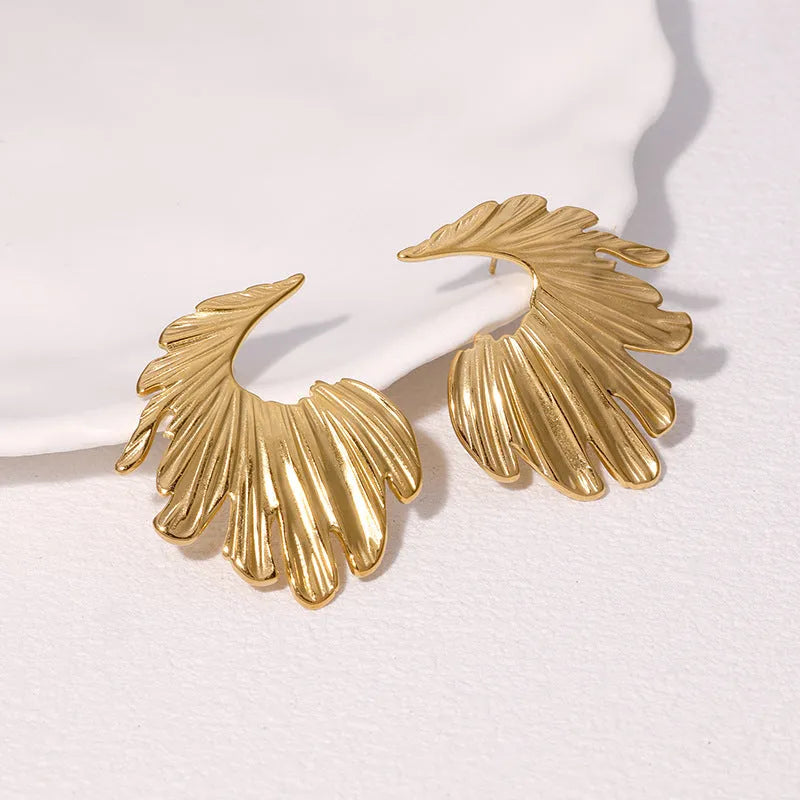 Pair of gold electroplated stainless steel leaf-shaped stud earrings on a white background