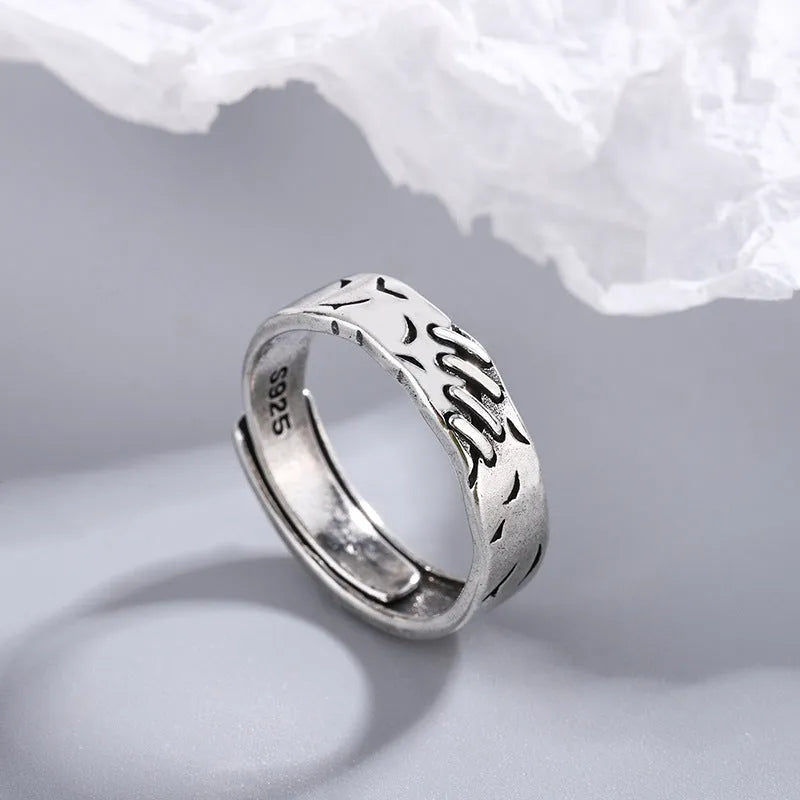 Black geometric adjustable ring with copper construction and round oval elements