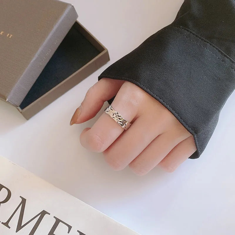 Black geometric adjustable ring with copper construction and round oval elements