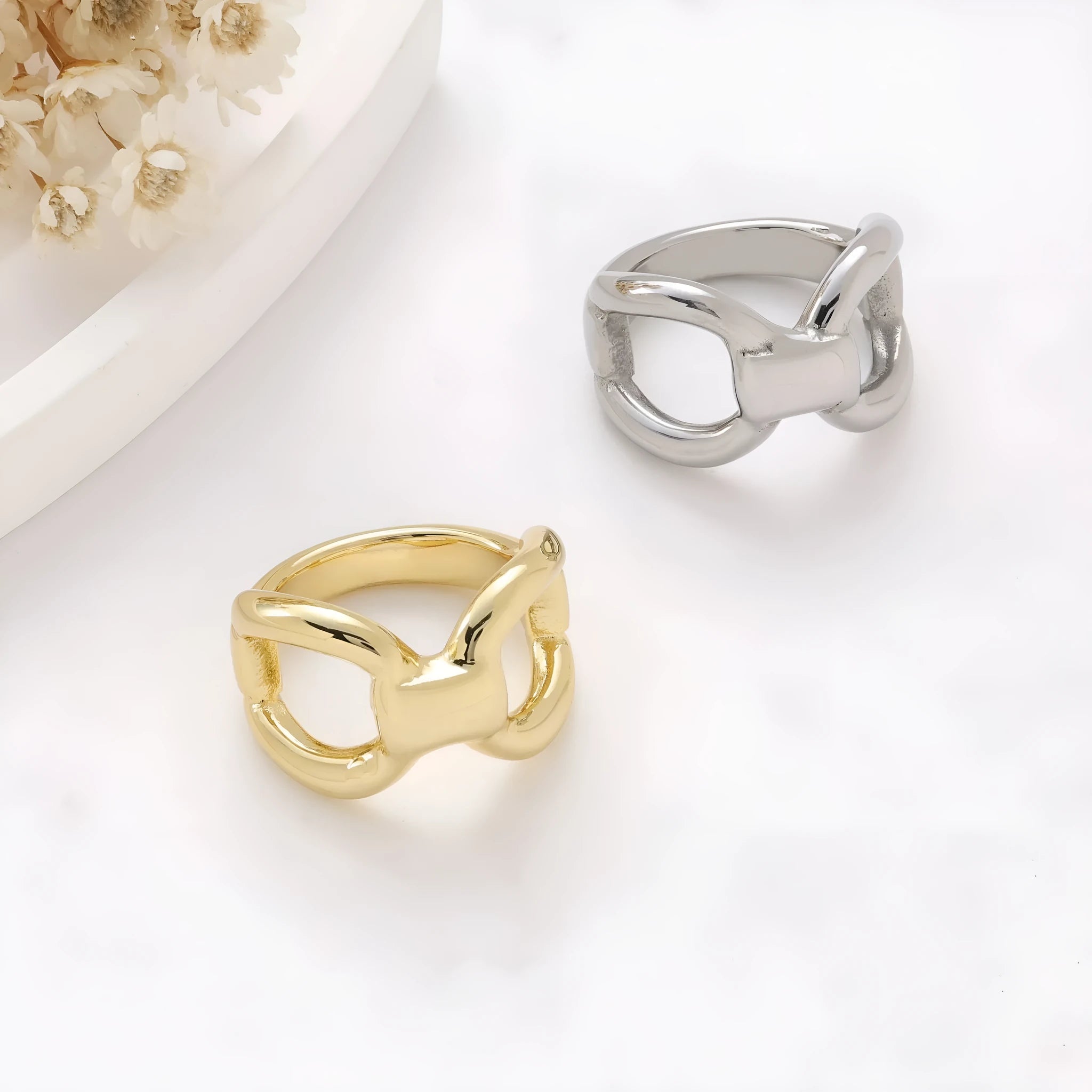 Simple fashion butterfly hollow women's ring in titanium steel gold colour on plain background