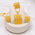 Gold colour copper bridal jewellery set with necklace, earrings, and ring on display