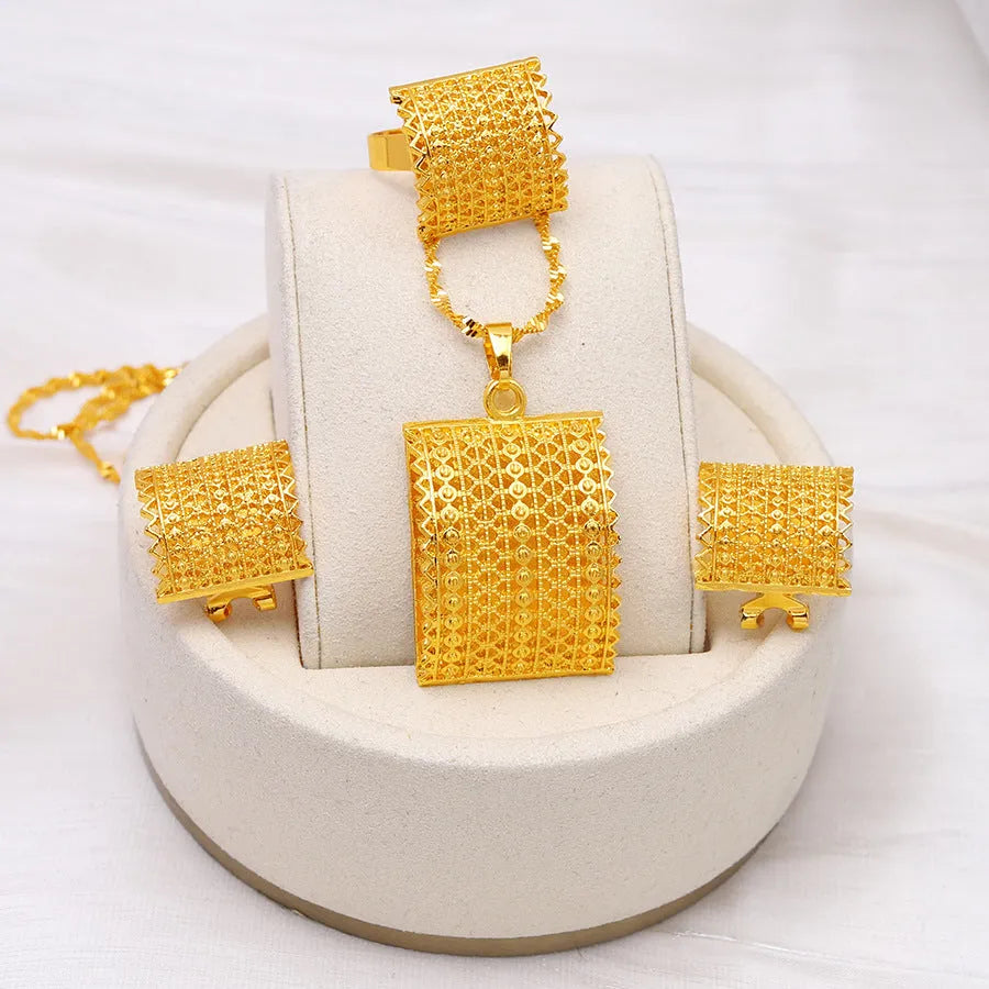 Gold colour copper bridal jewellery set with necklace, earrings, and ring on display