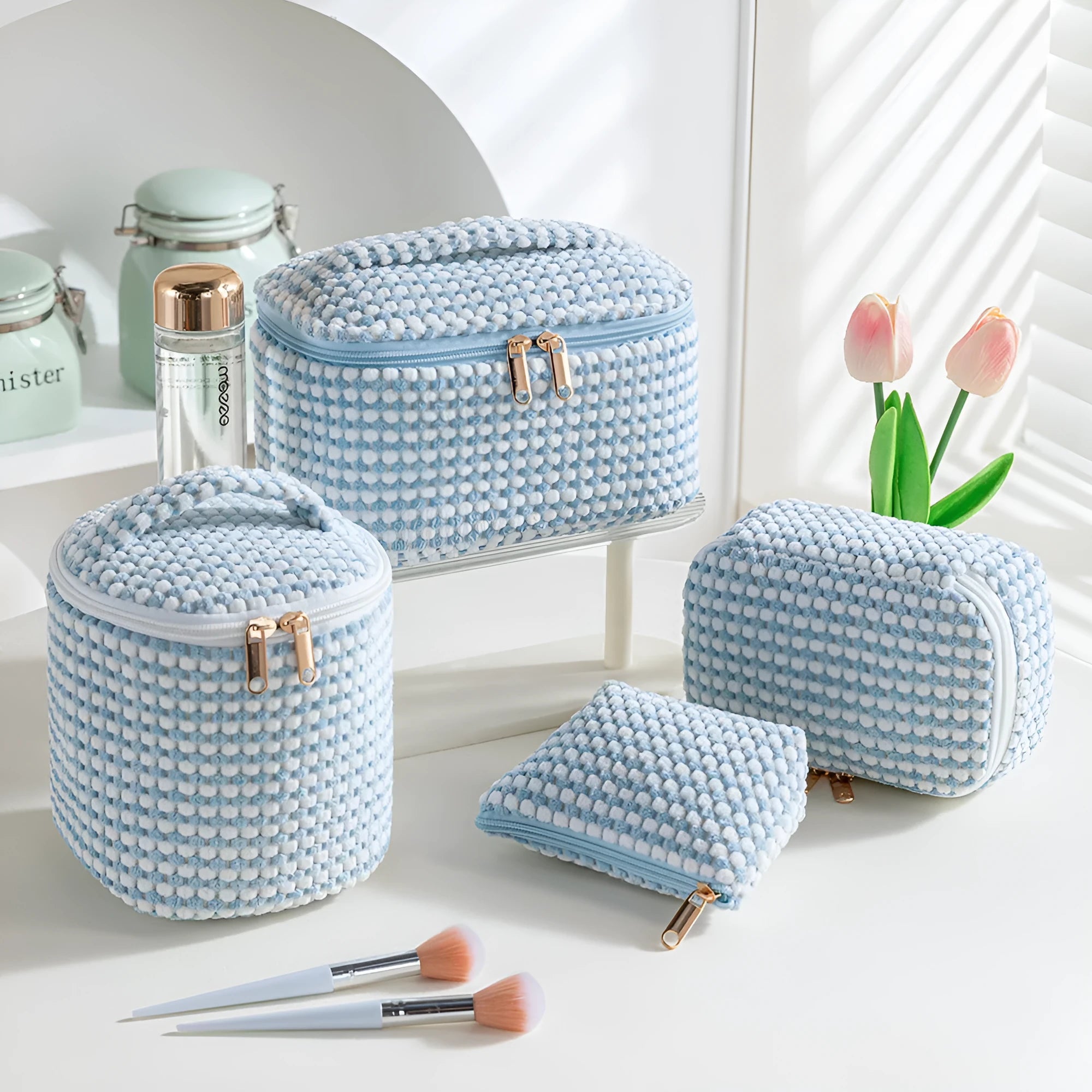 Four cube-style polyester makeup bags in different colour patterns including pink, khaki, and dotted designs