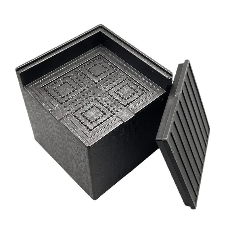 Four black thickened plastic floor mats for furniture leg levelling
