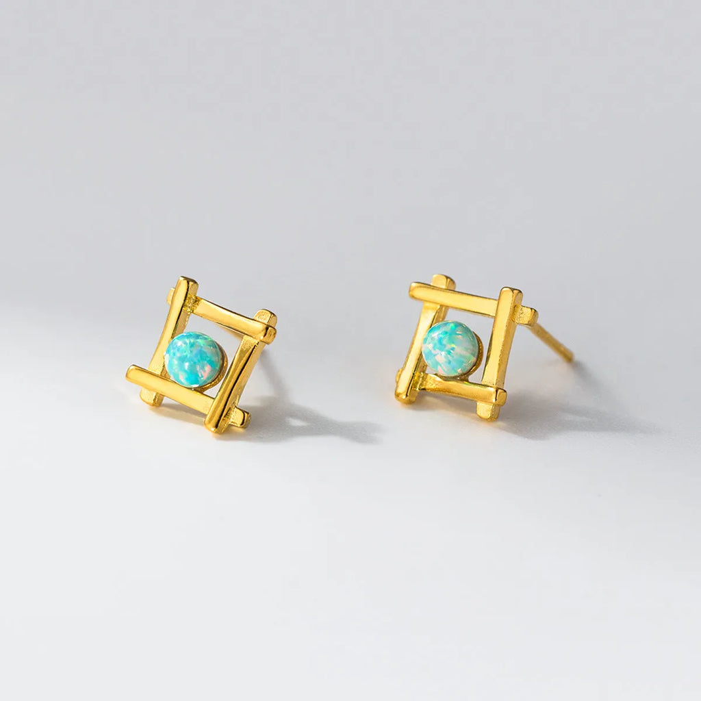 Geometric cross stud earrings in sterling silver with quadrangle shape and butterfly fastenings