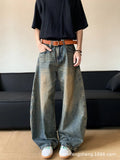 Man wearing retro blue distressed denim wide-leg trousers with a slim fit and zipper fly