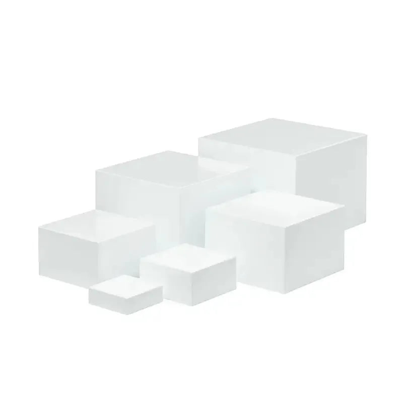 White plastic suit cube stacking dessert display stand with six pieces arranged for cake presentation.