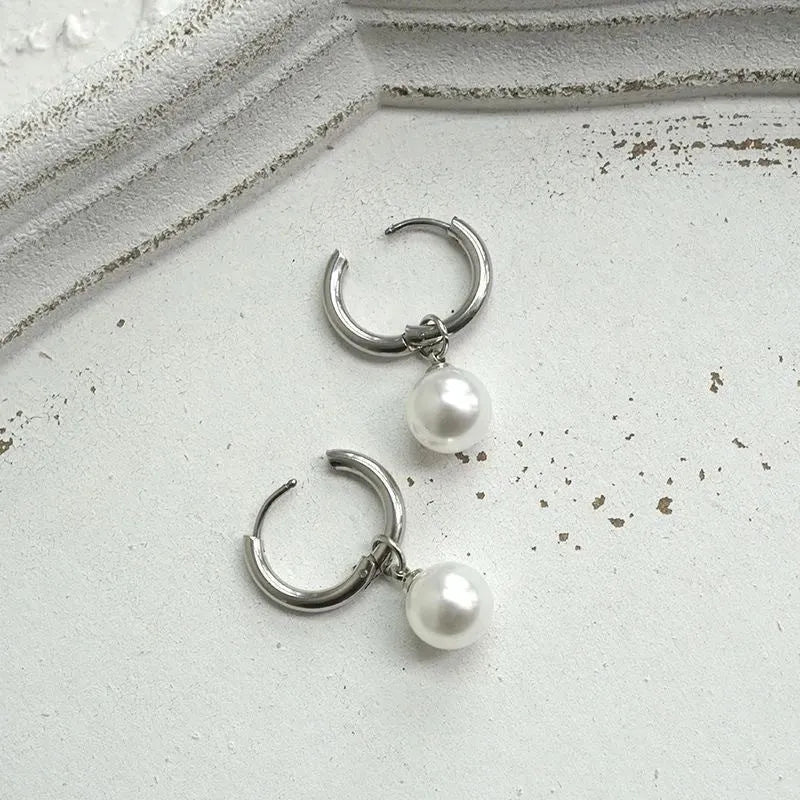 Pearl-coloured geometric round alloy earrings with dangle drop design and titanium steel posts