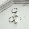 Pearl-coloured geometric round alloy earrings with dangle drop design and titanium steel posts