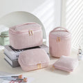 Four cube-style polyester makeup bags in different colour patterns including pink, khaki, and dotted designs