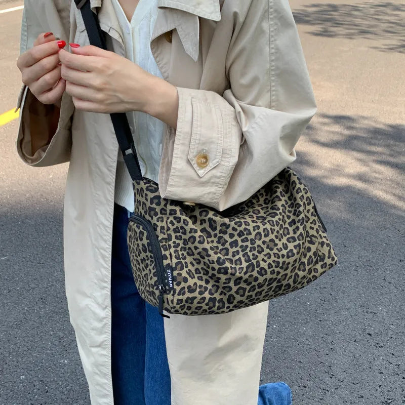 Large capacity sports style messenger bag in leopard print or striped pattern with cross-body strap