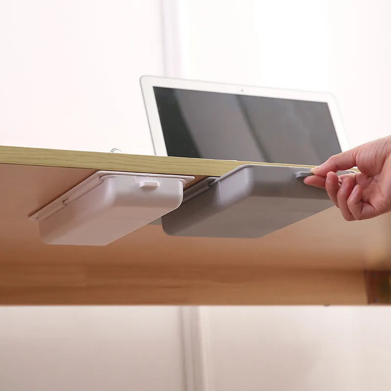 White plastic adhesive storage drawer with cover and internal grid compartments for under-desk organisation