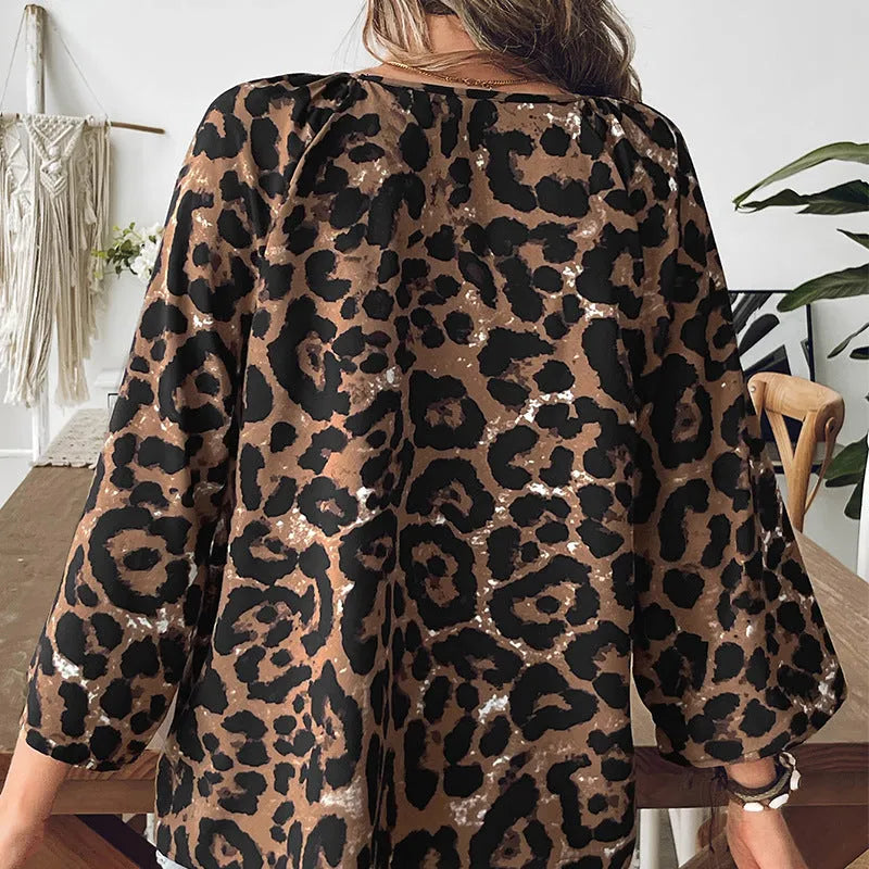 Women's multicolour leopard print V-neck pullover top with half sleeves.